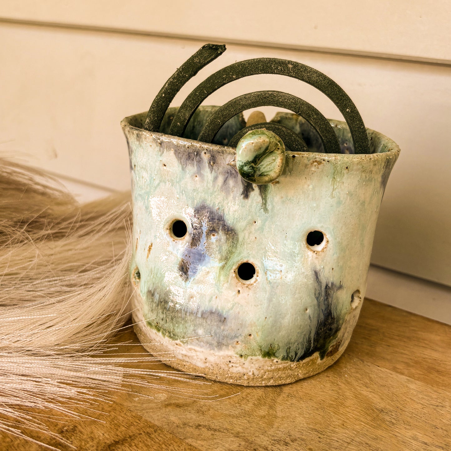 Handmade mosquito coil holder, blue skies, front shot