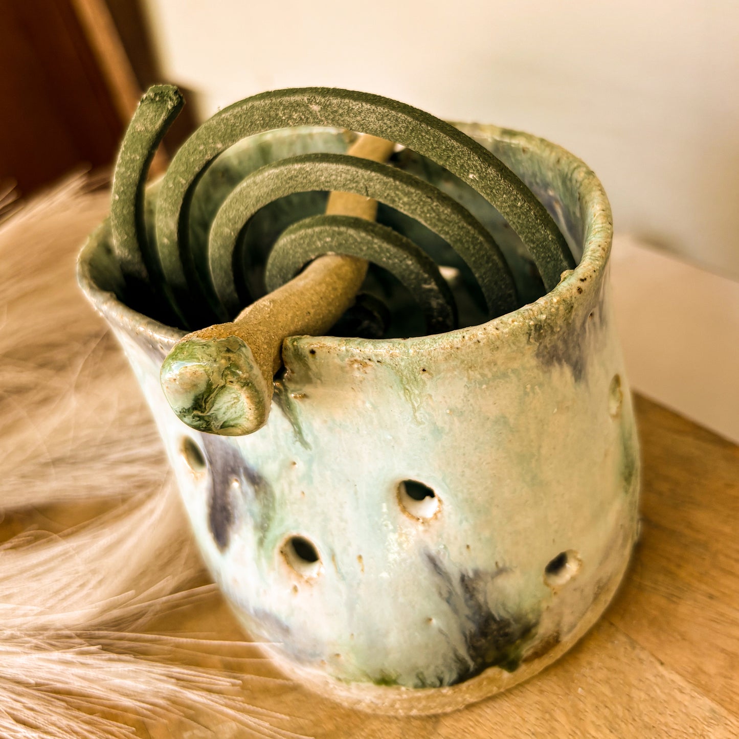 Handmade mosquito coil holder, blue skies, side angle shot