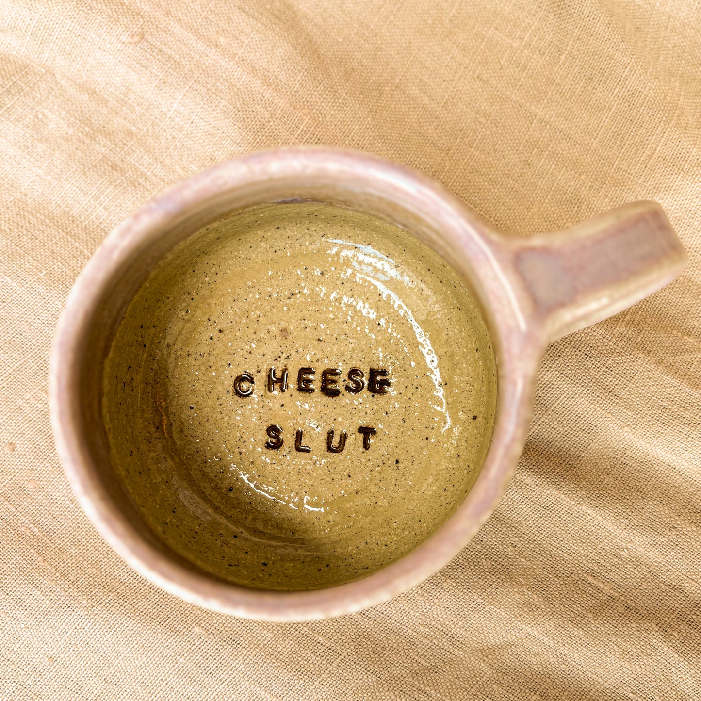 Handmade mug, purple, cheese slut, overhead shot