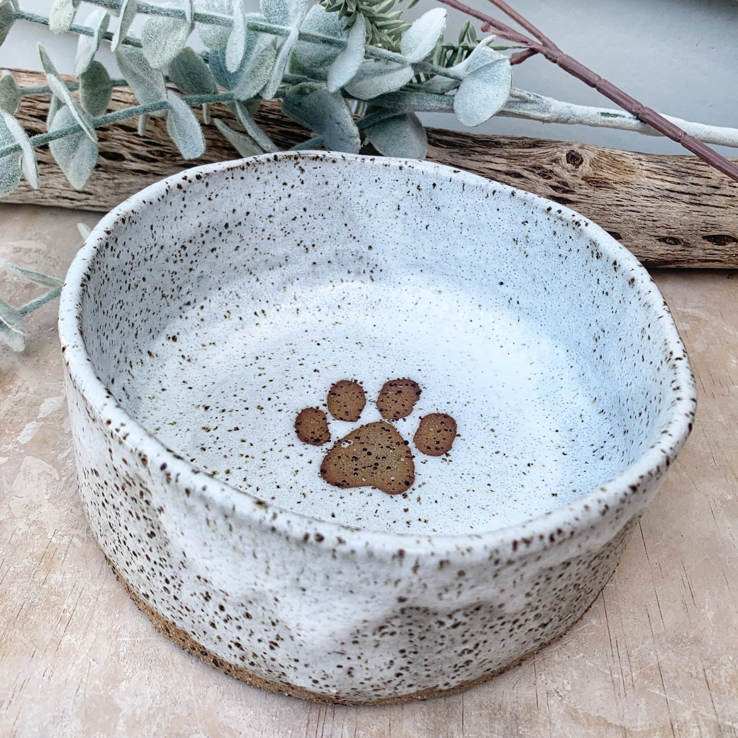 Handmade dog bowl, paw print, overhead shot